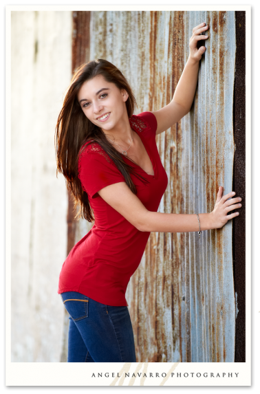 High School Senior Leaning on Rusty Door